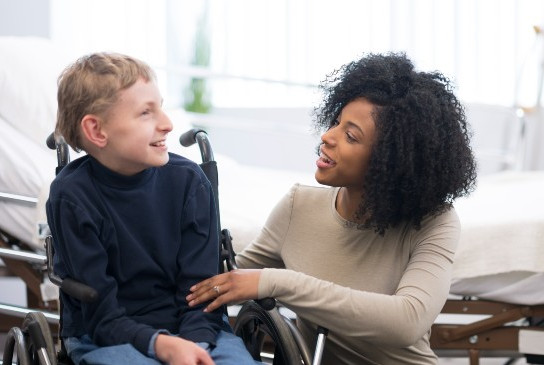 A boy talking with a care provider