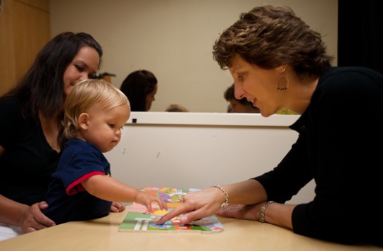 Two women playing with a baby