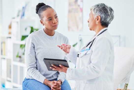 A woman speaking with a physician