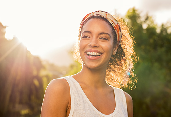 Young sunlit women smiling and looking hopeful
