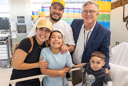 UC Davis patient with Duchenne muscular dystrophy receives gene infusion therapy, photo with family and Dr. Craig McDonald
