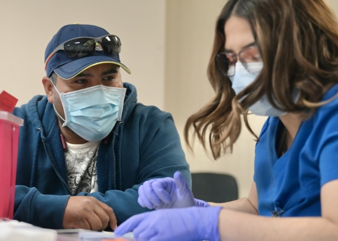 UC Davis Health nurse assisting patient