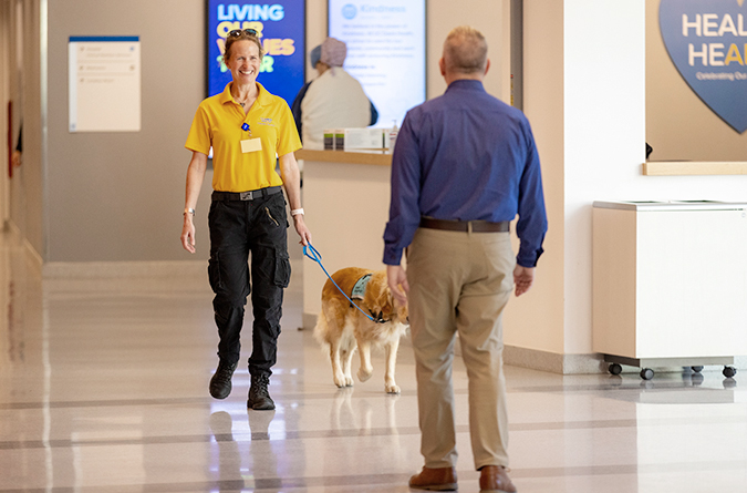 K9 volunteer greeting a patient.