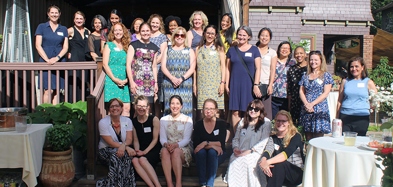 This image shows a group of female health professionals gathered for an outside event for the UC Davis Women in Medicine and Health Sciences group