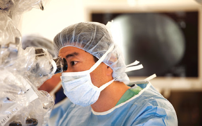 Dr. Kim at the surgical microscope