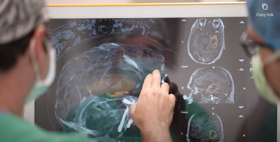 WATCH VIDEO - Residents looking at a brain imagery on a large touch screen computer