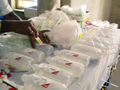 A photo taken by Virginia LeBaron shows a nurse in India preparing pre-chemotherapy medications without adequate protective gear. (c) UC Regents. All rights reserved.