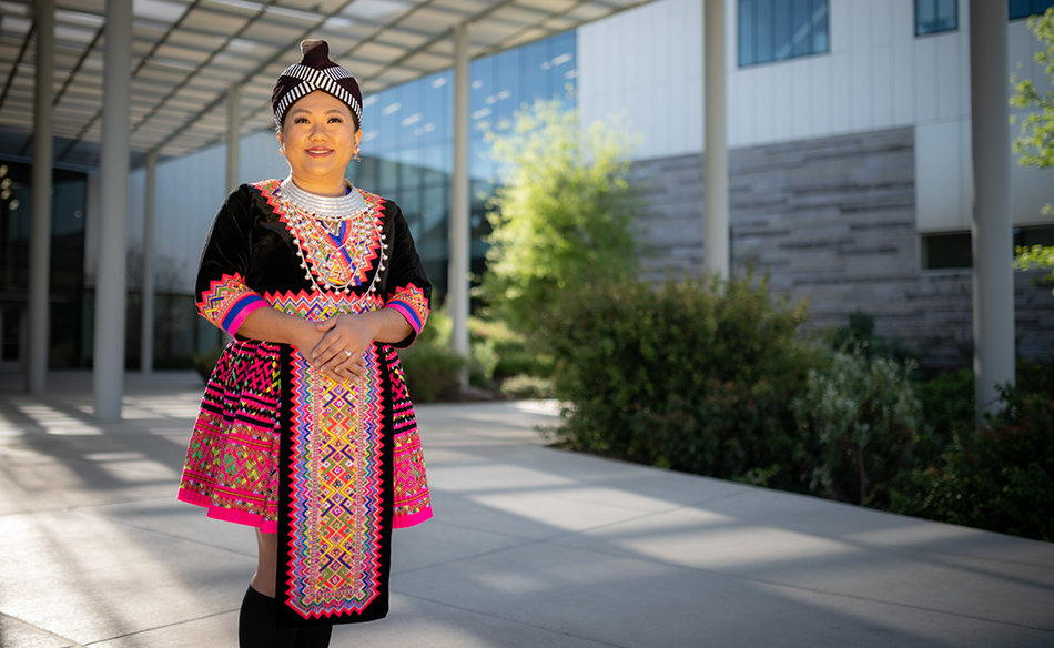 PhD candidate Kaykay Vang in traditional Hmong clothing.