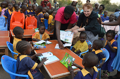 Laura Van Auker in Kenya distributing books to children.