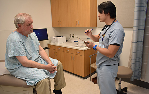 a physician assistant student with a patient in an exam room
