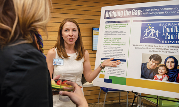 Master’s-degree leadership student Lauren Rountree presented her group’s project connecting Afghan refugees with medical interpreter positions.