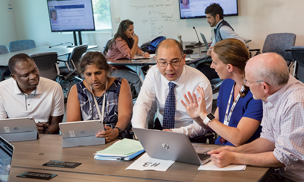 From left, clinical faculty Gerald Kayingo, Sumathi Sankaran-Walters, Brent Luu and Cara Sandholdt, as well as staff specialist Andrew Corbett, discuss enriching curricula with active learning opportunities.