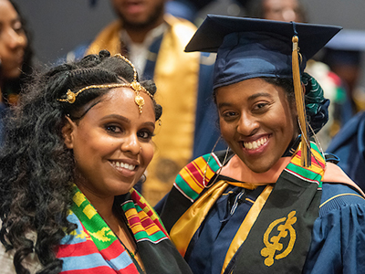 two black women in graduation cap and gown