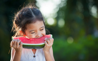 Young girl eating watermelon slice