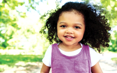 Child smiling at the camera. (C) UC Davis Regents. All rights reserved. 