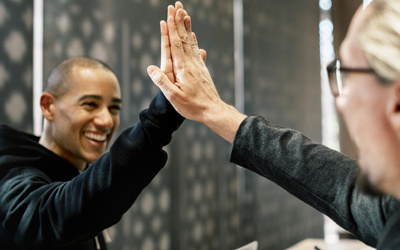 Two men giving each other a high five. (C) Pixabay. All rights reserved.