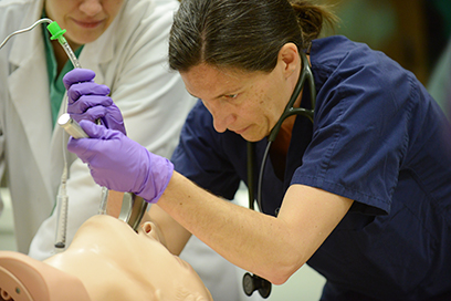 Woman practicing airway management.