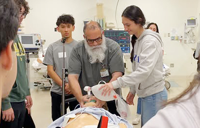 A simulation specialist trains a group of learners. (C) UC Regents. All rights reserved.