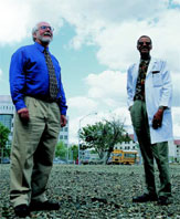 PHOTO -- Dennis Matthews and James Boggan on the empty lot where the new biophotonics center will take shape