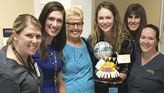 Barbara Mooney, center, and cancer center staff celebrate her 100th chemotherapy dose.