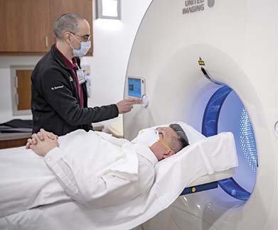 doctor with patient in scanner