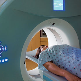 female entering CT scanner