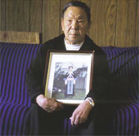 PHOTO -- Chong Yia Xiong of Stockton displays a photo of his late wife, Chou Vang, who died of cancer. UC Davis offers Hmong-speaking "navigators" to help families through cancer treatment