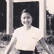 Asian woman standing outside looking at the camera