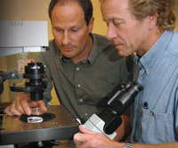 PHOTO — Thomas Huser (left) and Douglas Taylor use a breakthrough application — laser tweezers Ramen spectroscopy — to identify cancer cells earlier than conventional diagnostic methods.