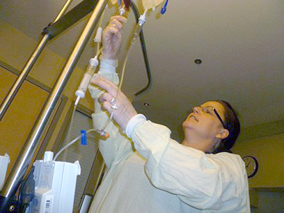 Nurse adjusting IV fluids